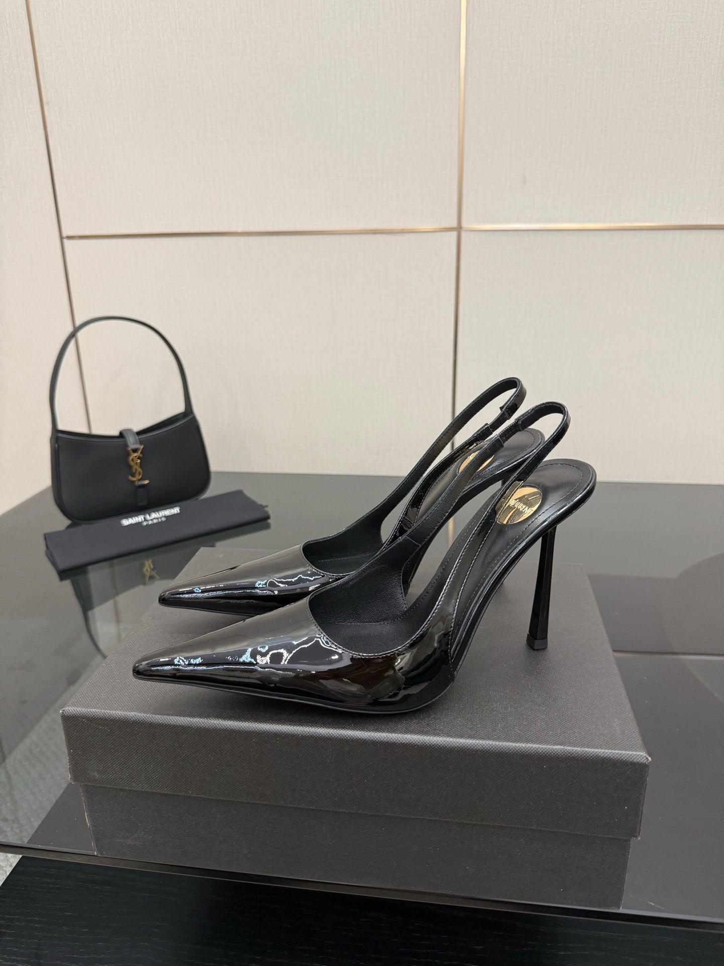 YSL women’s black pointed-toe slingback heels on stiletto heel, glossy front