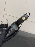 YSL women’s black slingback heel, close-up of pointed toe and gold emblem