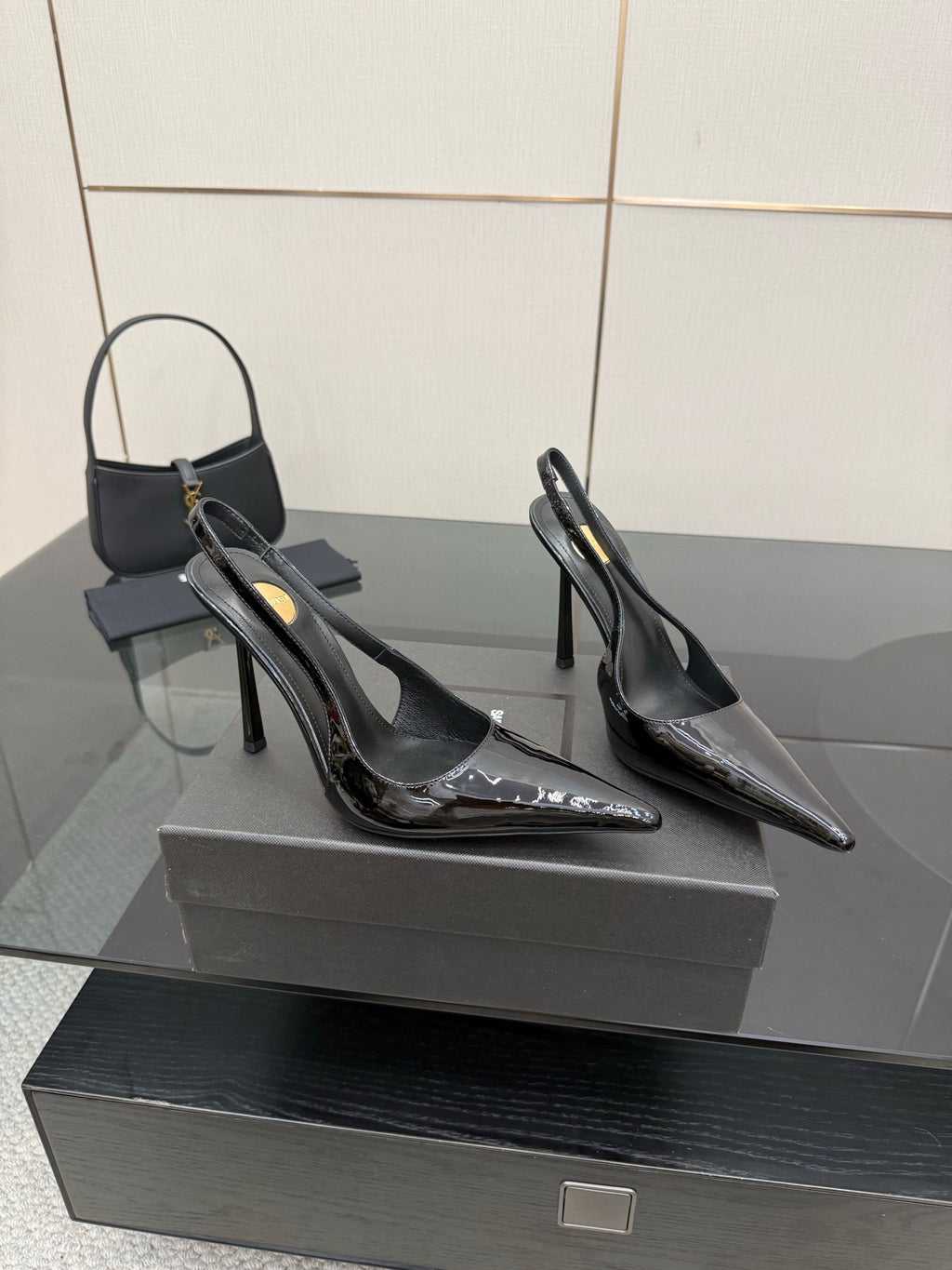 YSL women’s black pointed-toe slingback stiletto heels, angled side view