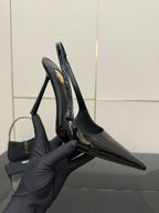 YSL women’s black stiletto slingback heels, close-up of glossy toe and heel