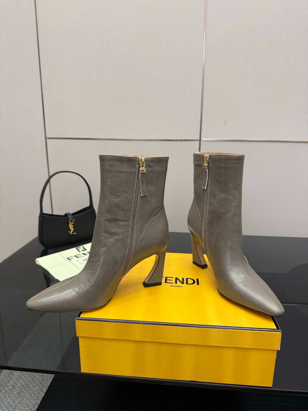 Fendi women’s ankle boots, silver-gray leather, back view showing zip pulls