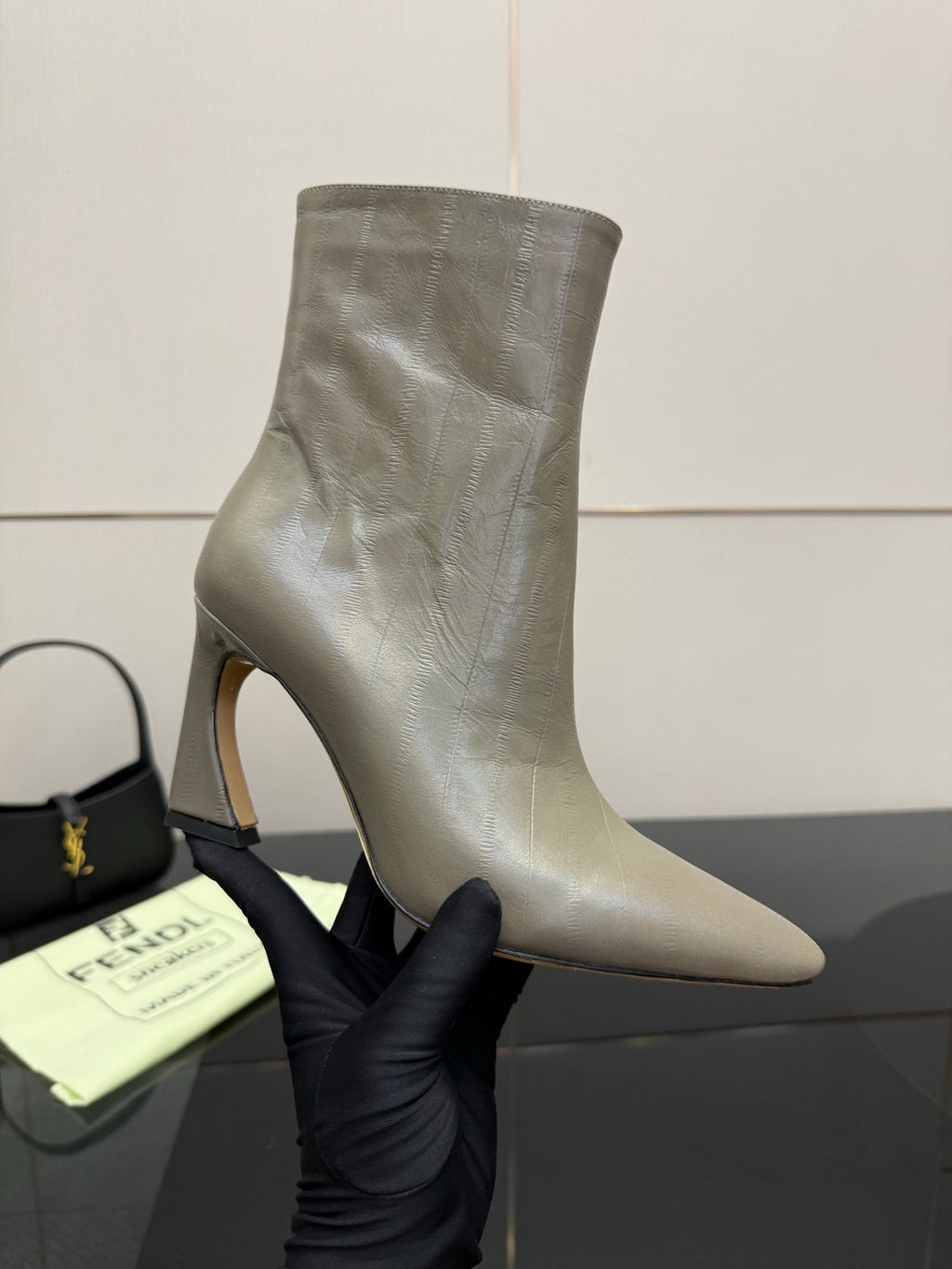 Fendi women’s ankle boot close-up, silver-gray leather, curved toe and block heel