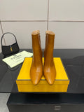 Pair of tan leather pointed-toe ankle boots with high heel and side zip