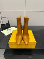 Pair of tan leather pointed-toe ankle boots with high heel and side zip