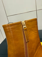 Tan leather ankle boot with gold-tone side zipper close-up