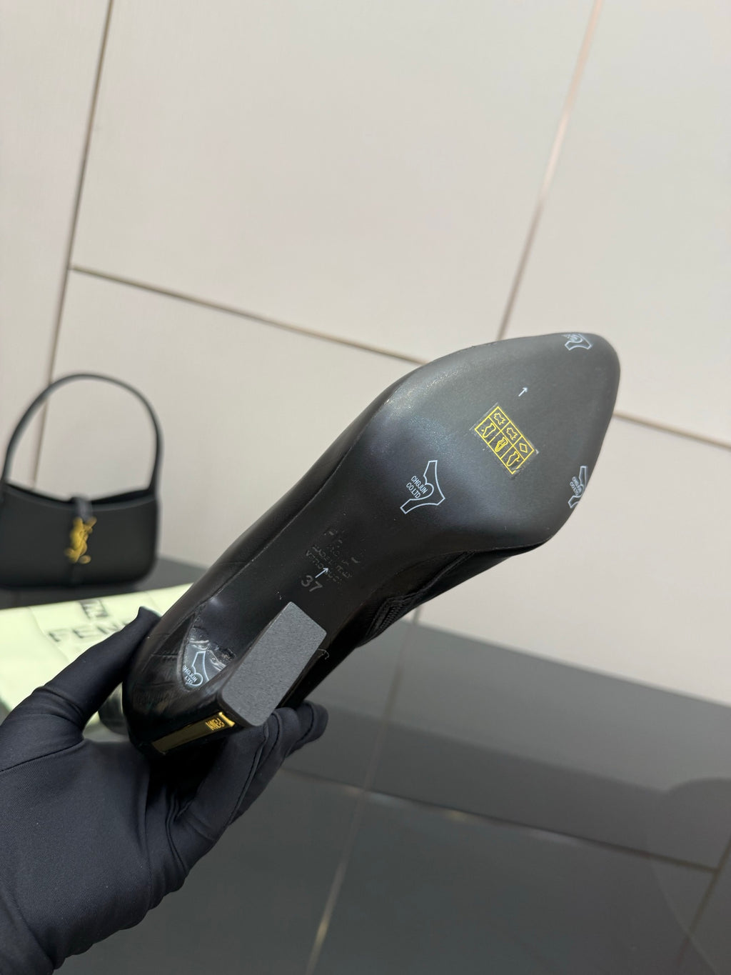 Black ankle boot sole and heel with printed logo and size markings