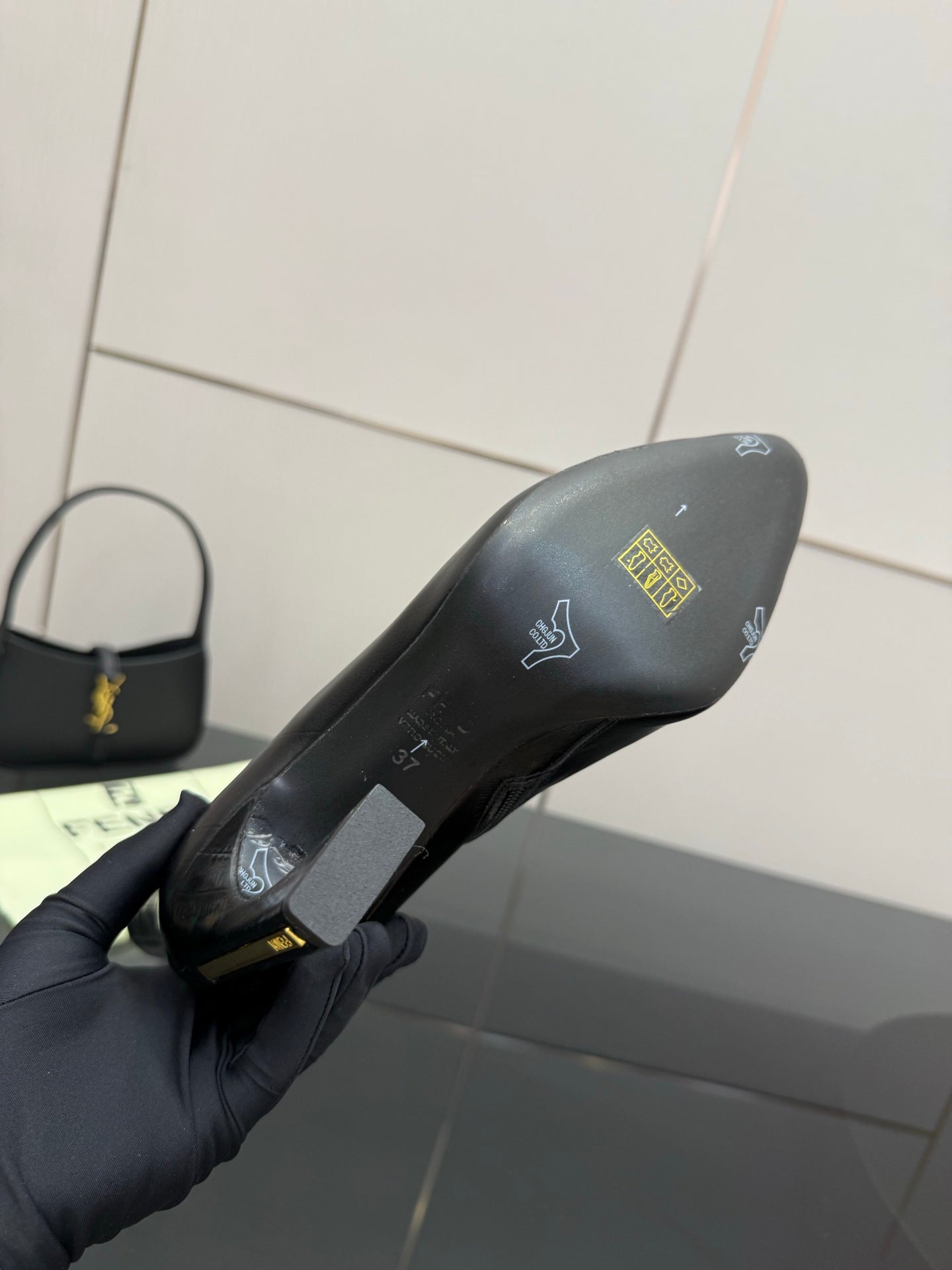 Black ankle boot sole and heel with printed logo and size markings