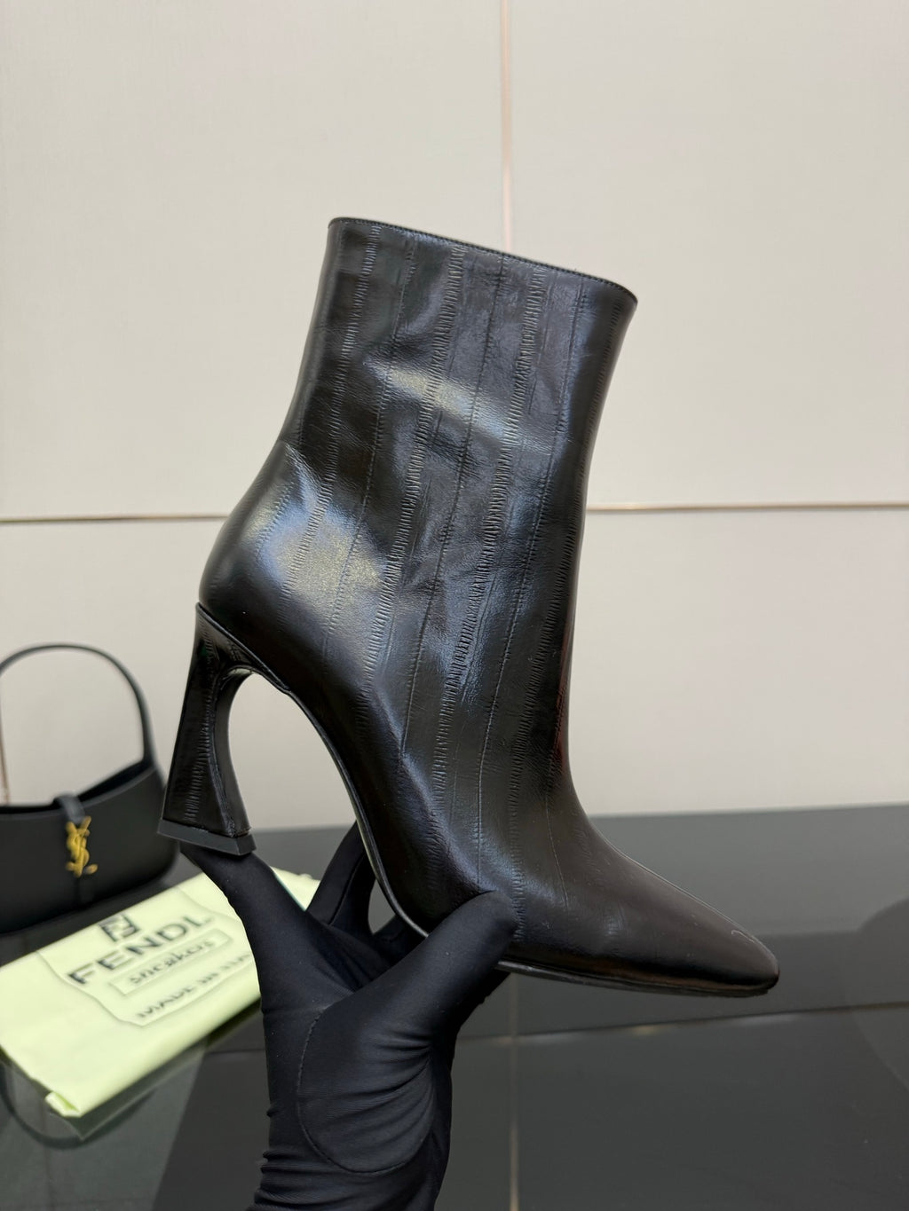 Women’s black leather ankle boots with slim high heel and pointed toe