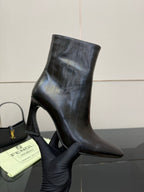 Women’s black leather ankle boots with slim high heel and pointed toe