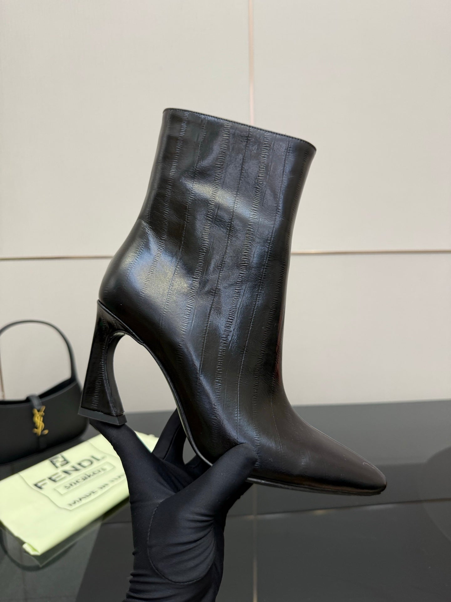 Women’s black leather ankle boots with slim high heel and pointed toe