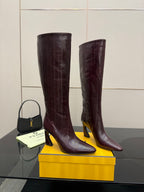 Pair of knee-high heeled boots in dark burgundy leather, pointed toe, gold-tone heel