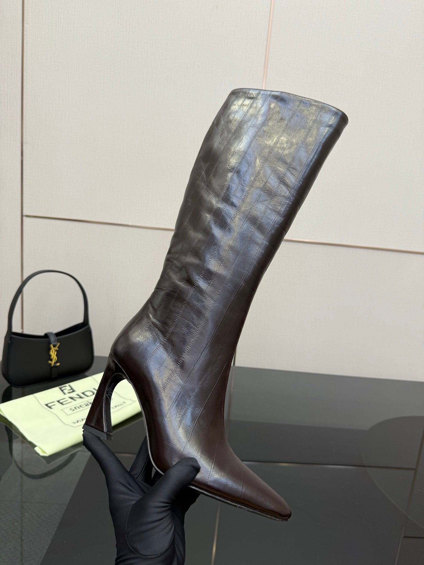 Ladies tall dark leather boot with slim heel and pointed toe