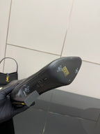 Dark boot toe area with logo markings on sole