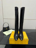 Pair of dark knee-high heeled boots with slim stiletto heel