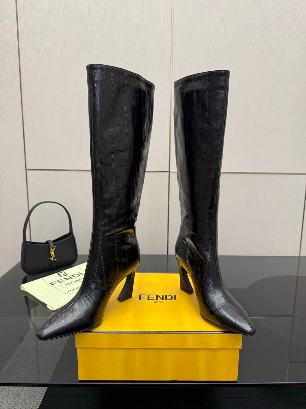 Dark knee-high heeled boots with FENDI logo on sole