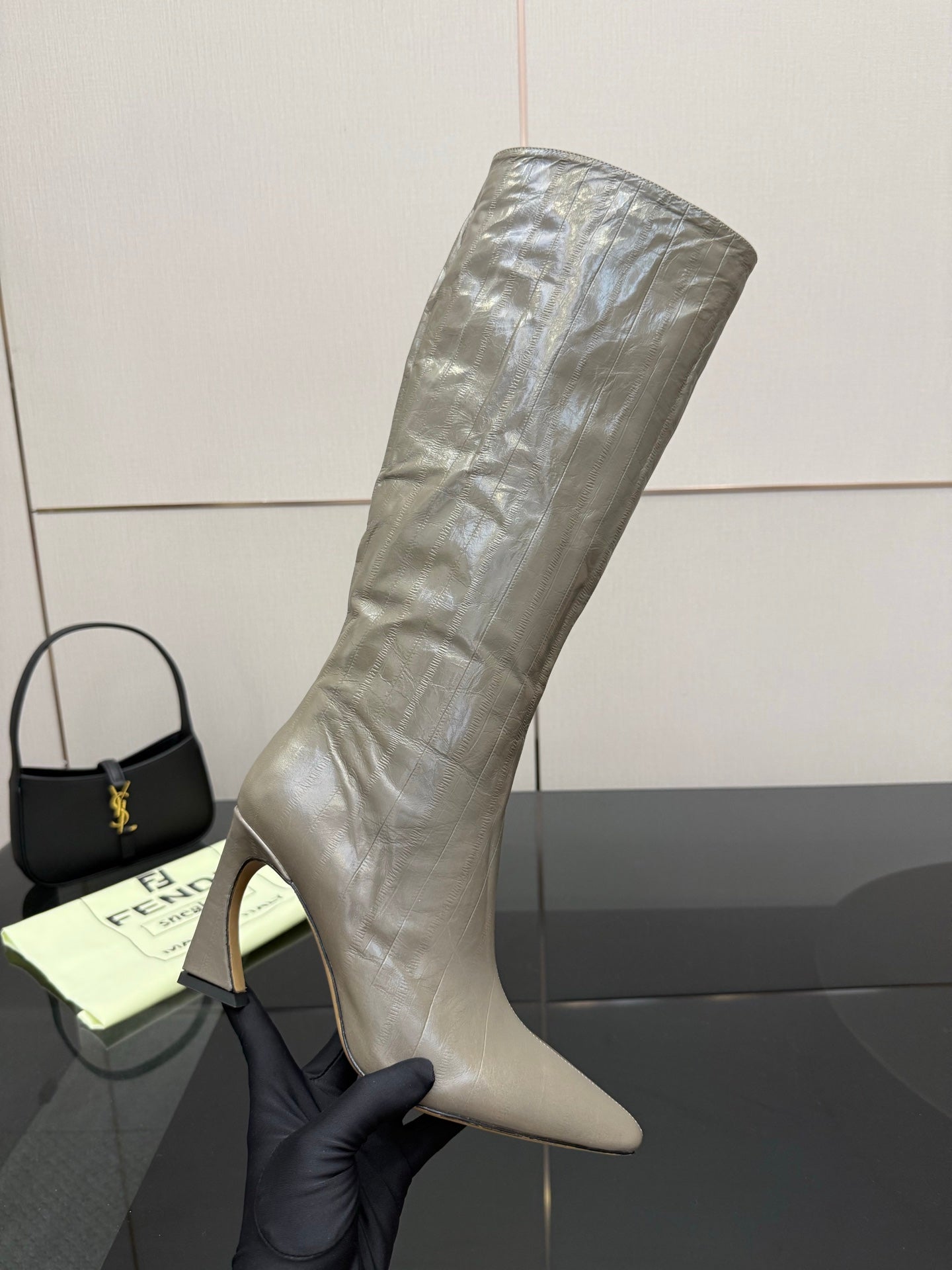 Single tall gray leather knee-high boot, pointed toe and stiletto heel