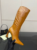Fendi women’s knee-high leather boots, tan, angled view with narrow stiletto heel.