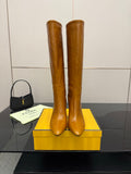 Fendi women’s knee-high leather boots, tan, tall stacked heel and pointed toe.