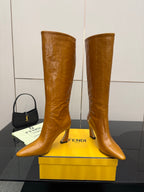 Fendi women’s knee-high leather boots, tan, profile view with pointed toe and stiletto heel.
