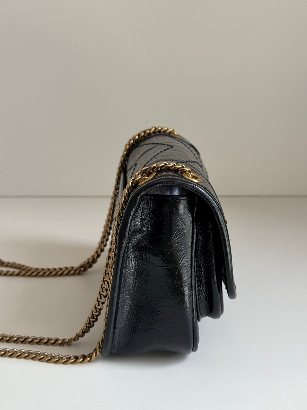 YSL dark leather crossbody bag with gold chain strap and flap front