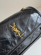 YSL dark leather flap bag with gold YSL emblem and decorative stitching