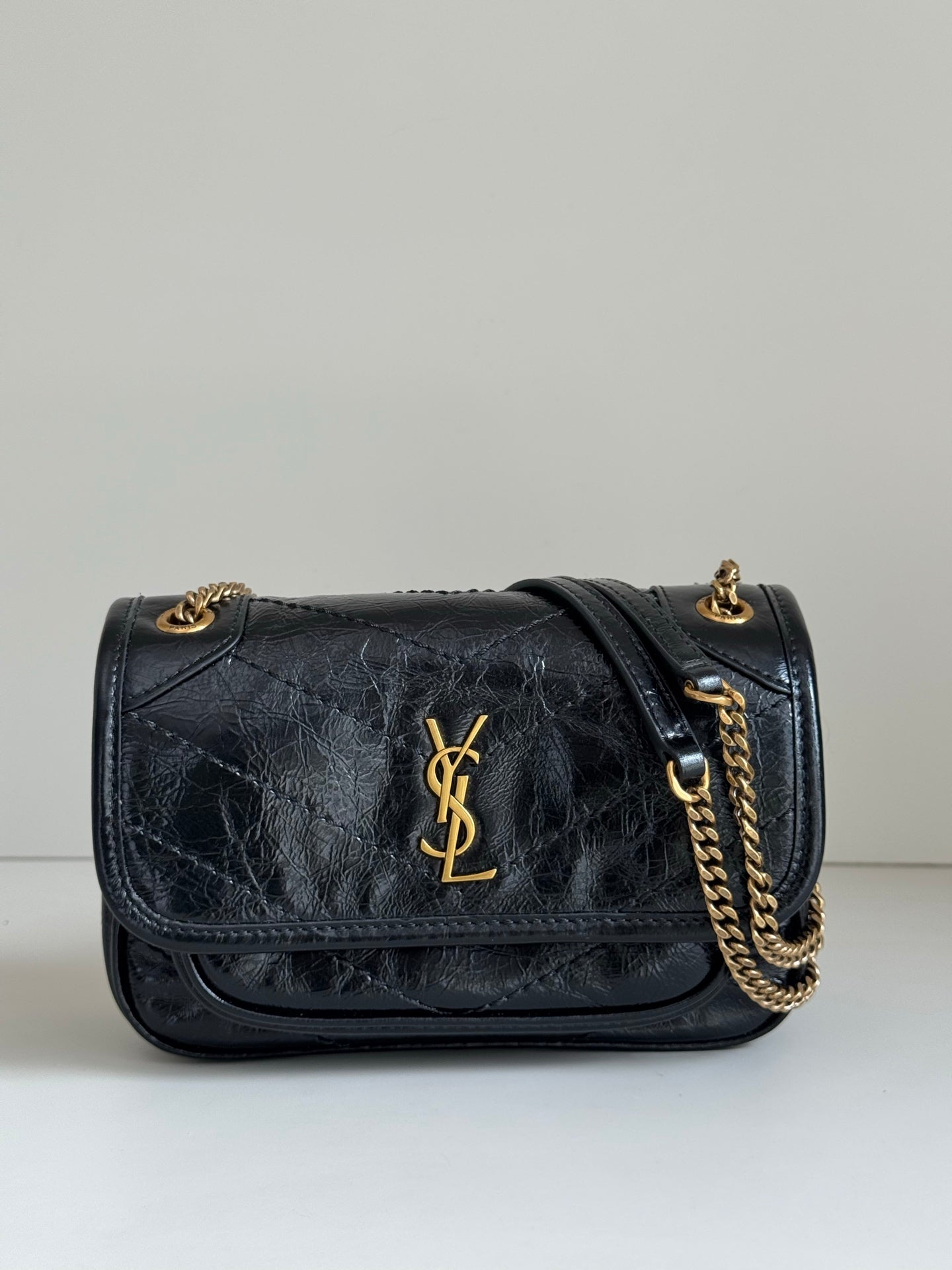 YSL black leather shoulder bag with gold YSL logo, flap and chain strap