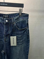 Balenciaga denim pants detail view, dark blue wash, button closure and coin pocket