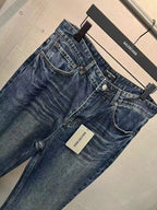 Balenciaga denim pants angled view, blue wash, front pockets and belt loops