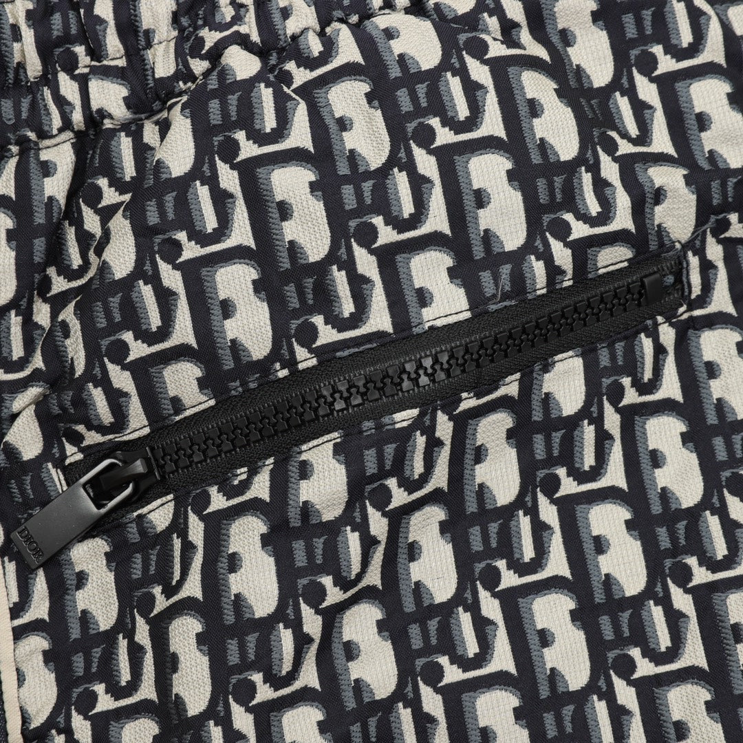 Pants front close-up showing zipper and Dior monogram pattern fabric