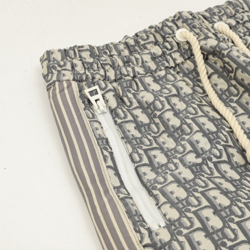 Dior monogram pants detail with elastic waistband, pocket, and side stripe panel