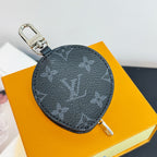 Louis Vuitton round zip key pouch with black monogram pattern and metal key ring