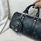 Louis Vuitton zip pouch with monogram canvas, black leather trim, and top handles