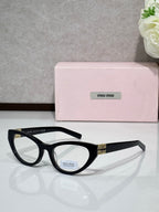 MiuMiu glasses with black acetate frame and gold logo temples