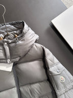 Gray puffer jacket chest with front zipper and small round logo patch
