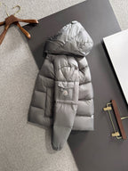 Gray long puffer jacket with attached hood, front zipper, and patch pocket on sleeve