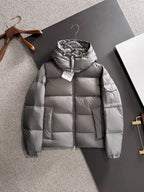 Gray hooded puffer jacket with full-length zipper and quilted front panels