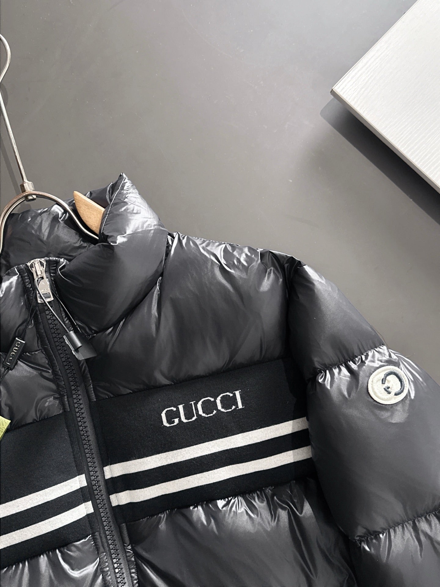 Gucci padded jacket in black with Gucci logo stripe near chest