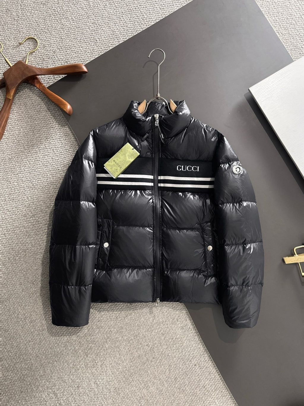 Gucci padded jacket in black with front zip and logo stripe across chest