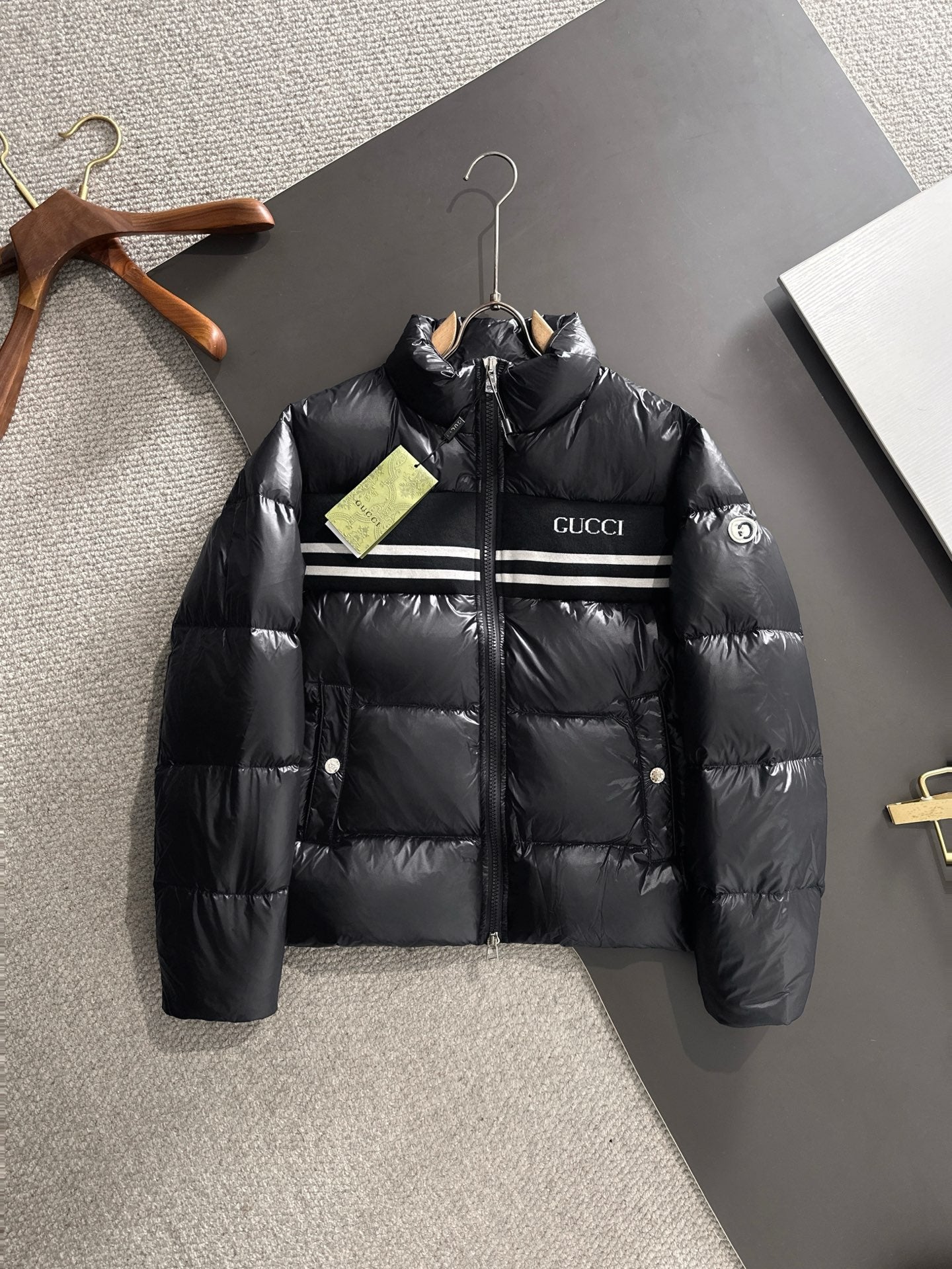 Gucci padded jacket in black with front zip and logo stripe across chest