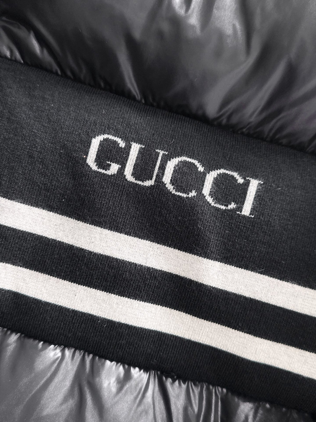 Gucci logo knit stripe on black padded jacket front