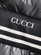 Gucci logo knit stripe on black padded jacket front