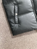 Dark gray puffer vest front panel with button placket detail