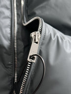 Dark gray puffer vest front zipper with metal pull and ring