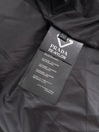 Prada RE-NYLON fabric label on black puffer vest
