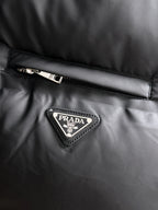Prada logo patch on black puffer vest chest panel
