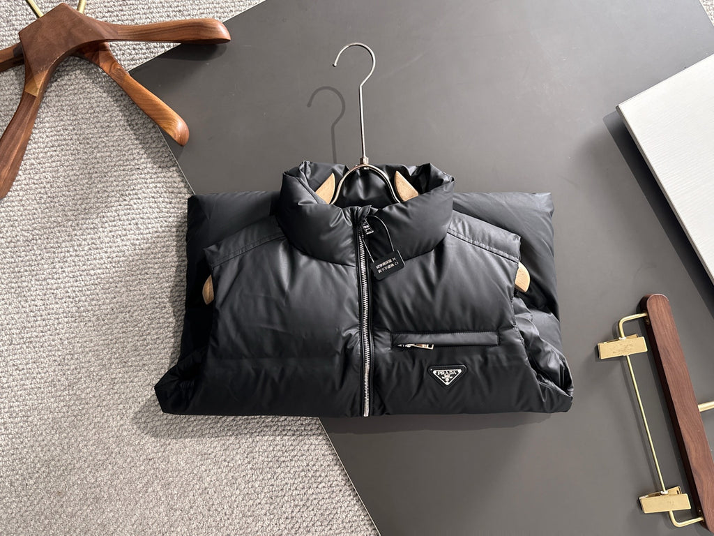 Prada black padded puffer vest laid flat, full-zip front