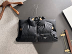 Prada black padded puffer vest laid flat, full-zip front