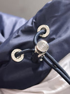 Gucci puffer jacket hood toggle and cord hardware on navy fabric