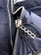 Gucci puffer jacket zipper pull and snap ring detail on navy fabric