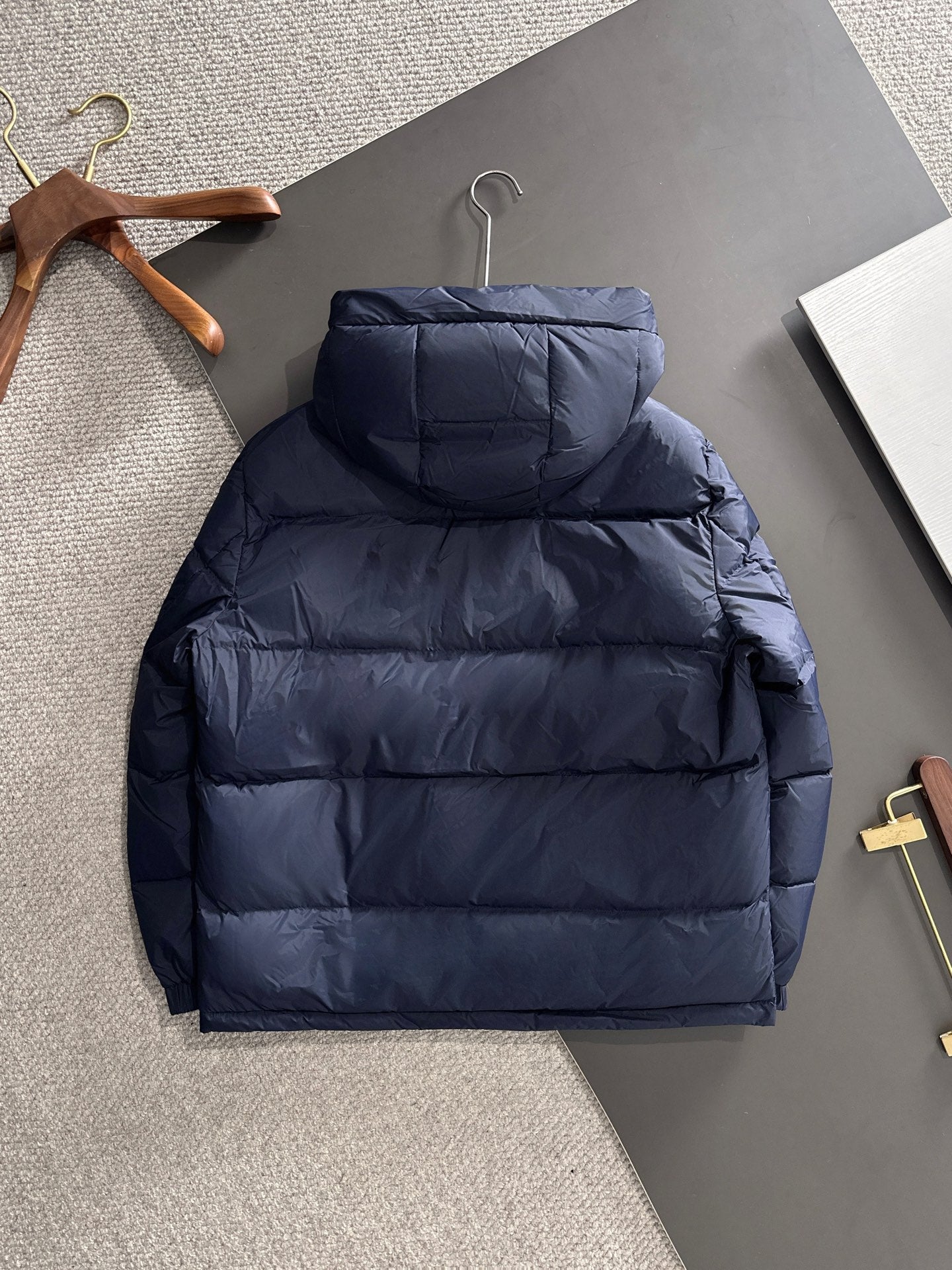 Gucci puffer jacket with hood, back view, navy blue quilted puffer design